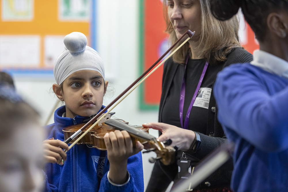Child and teacher with violin